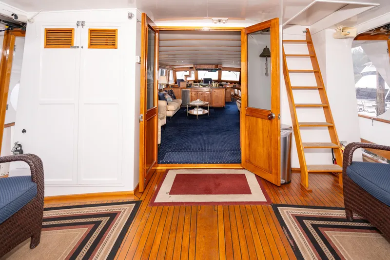 Slide: The Image of Luxurious 1980 McQueen Motoryacht interior with wooden flooring and elegant seating. - 9