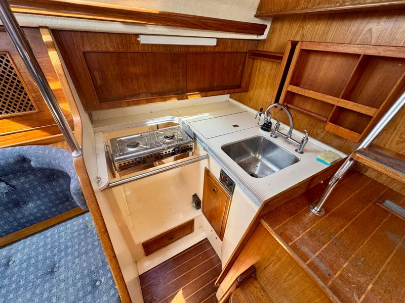 Slide: The Image of 1984 Camper & Nicholsons Nicholson 35 yacht interior with wooden navigation station and seating. - 10