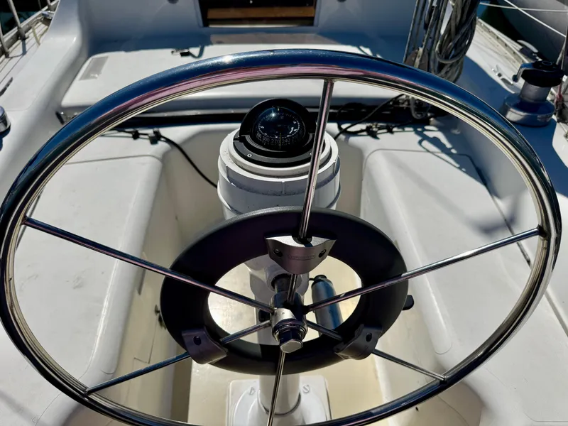 Slide: The Image of Interior of 1984 Camper & Nicholsons Nicholson 35 sailboat with wooden furnishings and blue seating. - 7