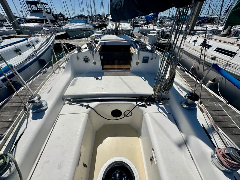 Slide: The Image of Interior of 1984 Camper & Nicholsons Nicholson 35 sailboat with wooden finish and blue seating. - 8