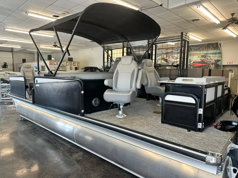 The Image of 2025 Premier Sunsation 230 Angler pontoon boat with canopy and seating in showroom. - 1