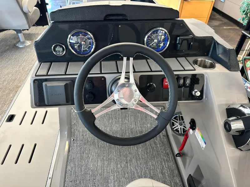 Slide: The Image of Steering console of 2025 Premier Sunsation 230 Angler with modern controls and gauges. - 10