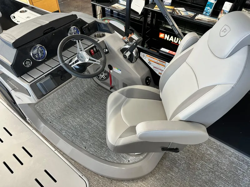 Slide: The Image of 2025 Premier Sunsation 230 Angler boat interior with steering wheel and captain's chair. - 9