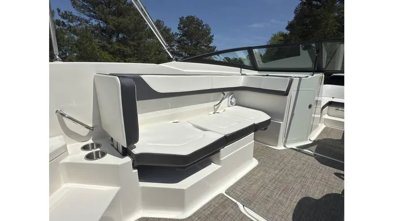 Slide: The Image of 2016 Sea Ray SPX 210 boat interior with cushioned seating and cup holders. - 10