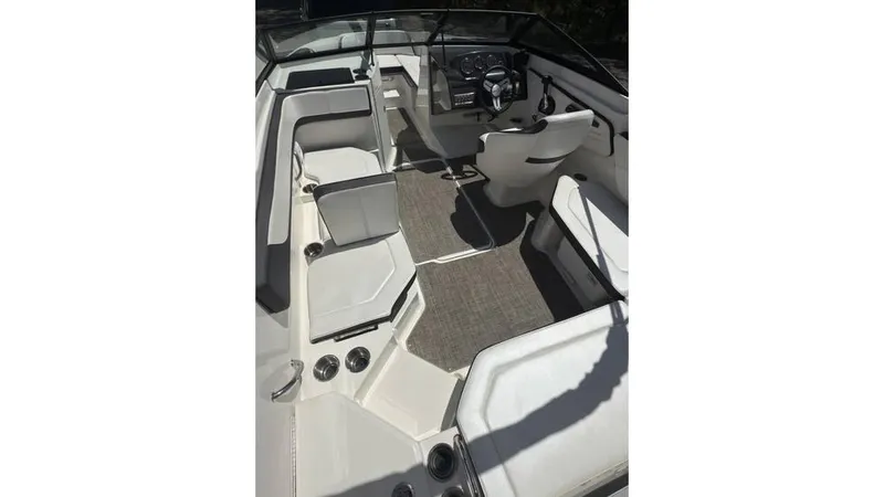 Slide: The Image of 2016 Sea Ray SPX 210 boat interior with seating and steering console. - 12