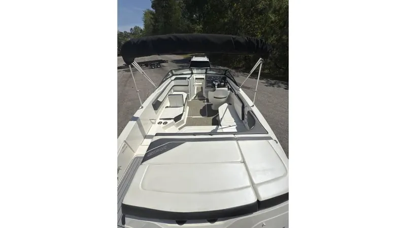 Slide: The Image of 2016 Sea Ray SPX 210 boat with canopy, viewed from above, parked on a sunny day. - 13