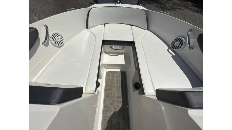 Slide: The Image of 2016 Sea Ray SPX 210 boat interior with white seating and speakers. - 7