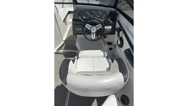 Slide: The Image of 2016 Sea Ray SPX 210 boat cockpit with steering wheel and gauges. - 8