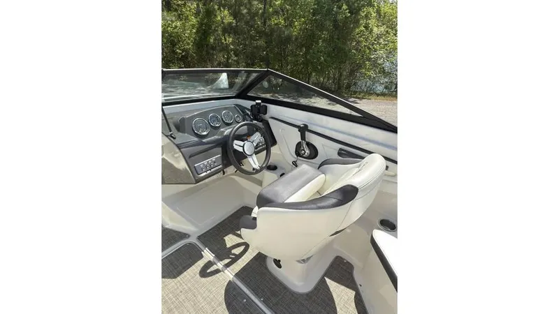 Slide: The Image of 2016 Sea Ray SPX 210 boat interior with steering wheel and dashboard. - 9
