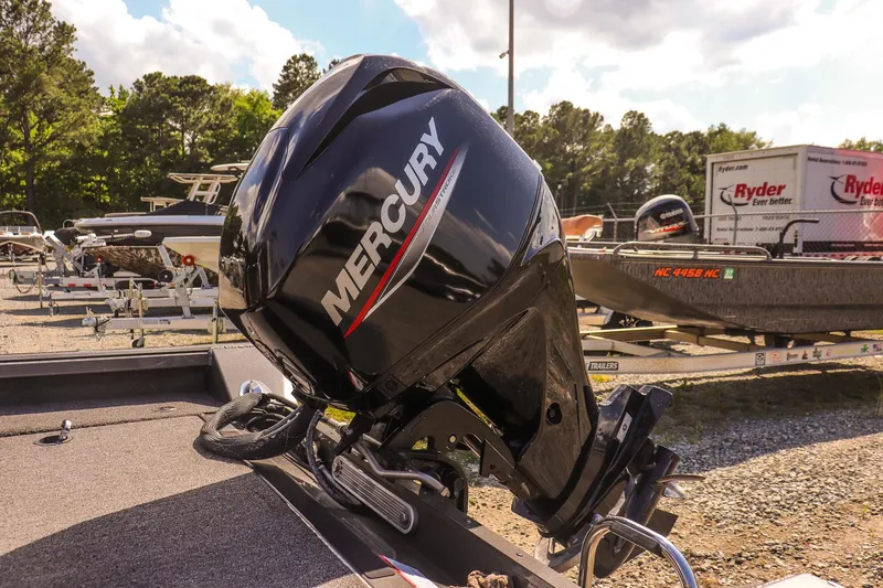 Slide: The Image of Outboard motor on a 2020 Ranger VS1660 SC boat, parked outdoors. - 15