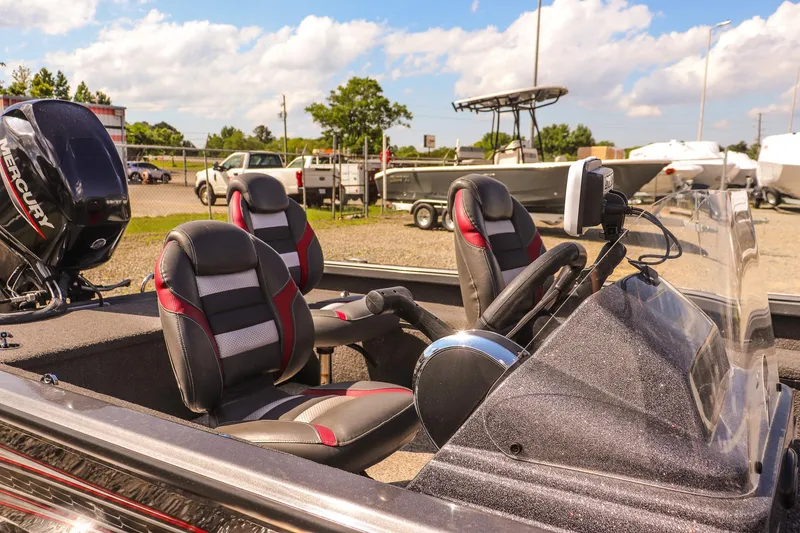 Slide: The Image of 2020 Ranger VS1660 SC boat with seating and console, parked outdoors under a sunny sky. - 21