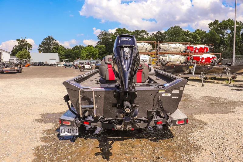 Slide: The Image of 2020 Ranger VS1660 SC boat with outboard motor, parked on gravel lot under blue sky. - 3