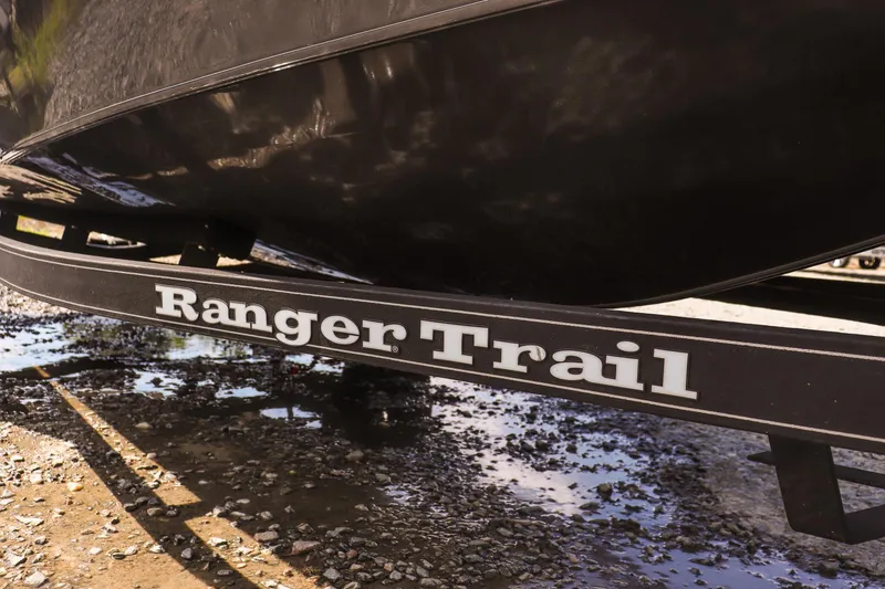 Slide: The Image of Ranger VS1660 SC 2020 boat on a Ranger Trail trailer, parked on gravel. - 8