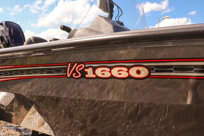 Slide: The Image of 2020 Ranger VS1660 SC boat with red and black detailing under a blue sky. - 9