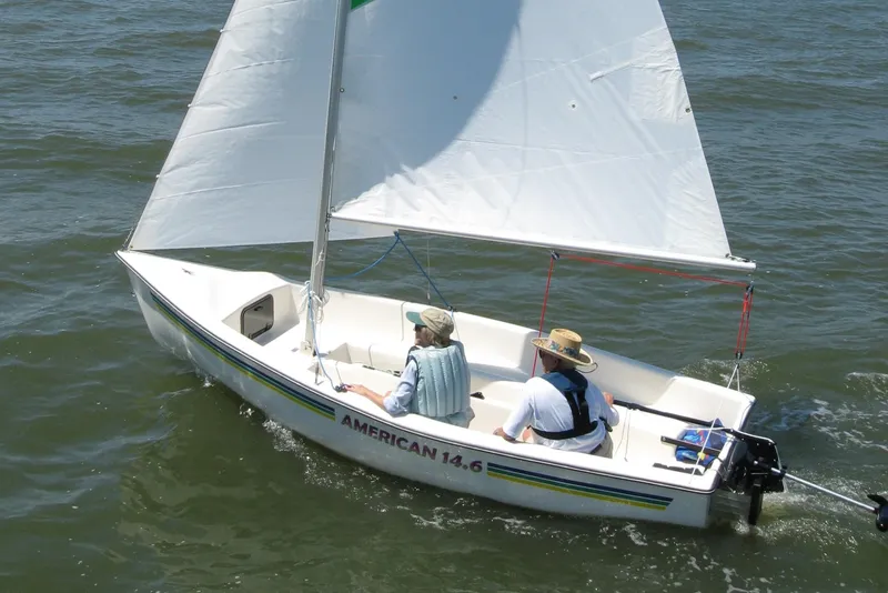 Slide: The Image of Sailboat American 14.6, 2025 model, sailing on open water with two passengers. - 5