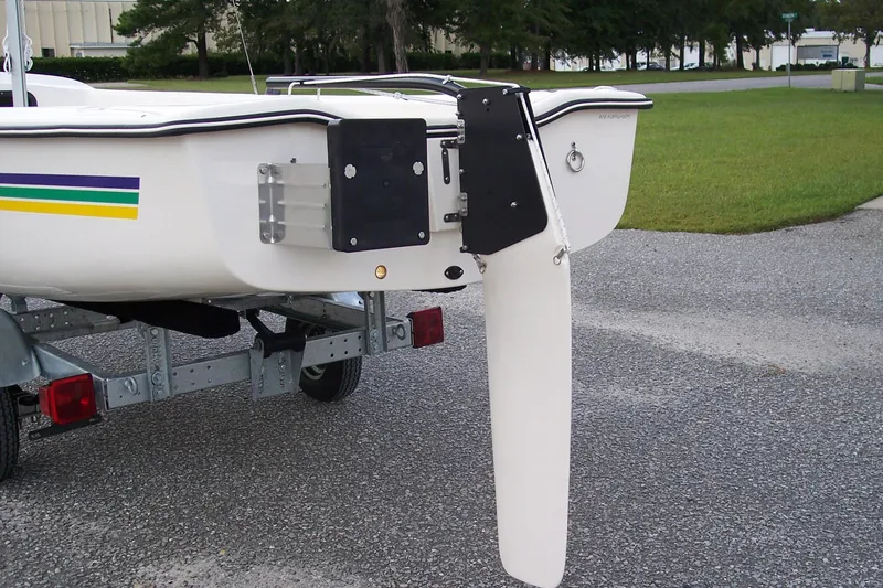 Slide: The Image of American Sail AMERICAN 14.6 boat, 2025 model, rear view with rudder and colorful stripe. - 7