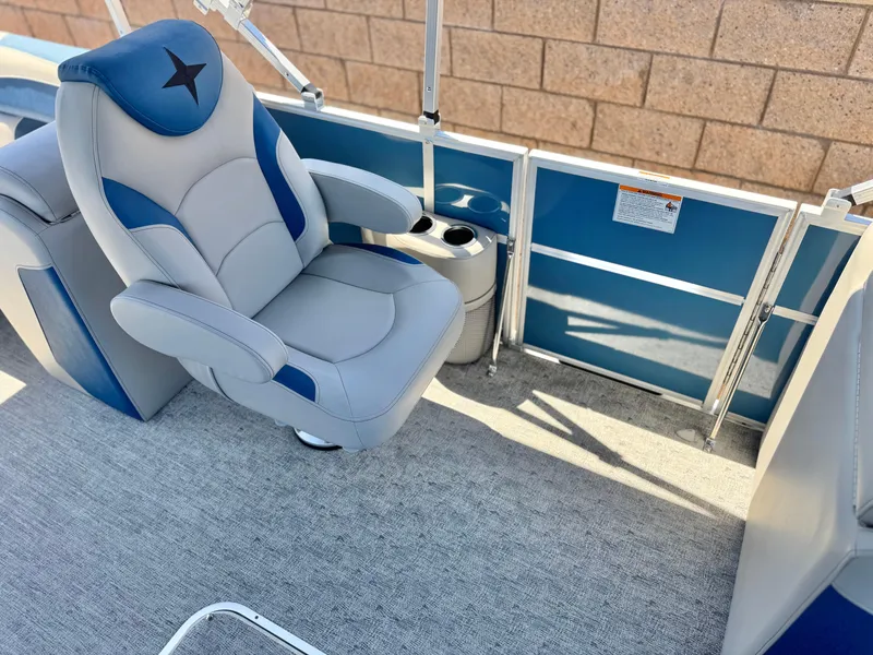Slide: The Image of 2025 Berkshire 22RFX LE boat interior with blue and gray seating and cup holder. - 12
