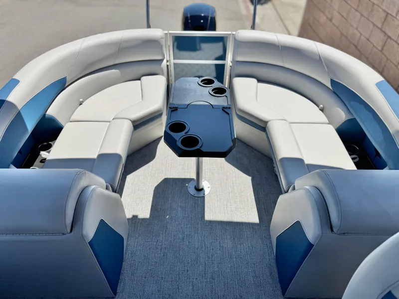 Slide: The Image of 2025 Berkshire 22RFX LE pontoon boat interior with plush seating and central table. - 13