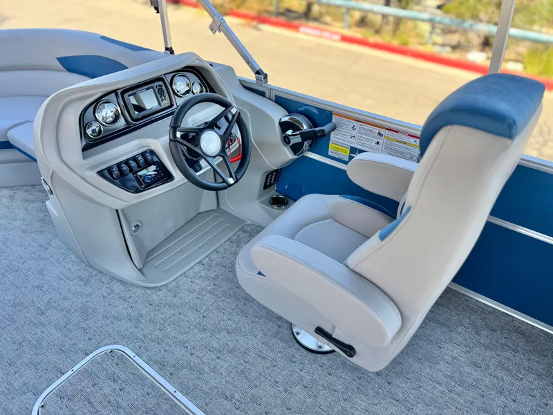 Slide: The Image of 2025 Berkshire 22RFX LE boat interior with modern steering console and comfortable seating. - 18