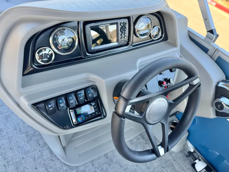 Slide: The Image of 2025 Berkshire 22RFX LE boat dashboard with steering wheel and control panel. - 20
