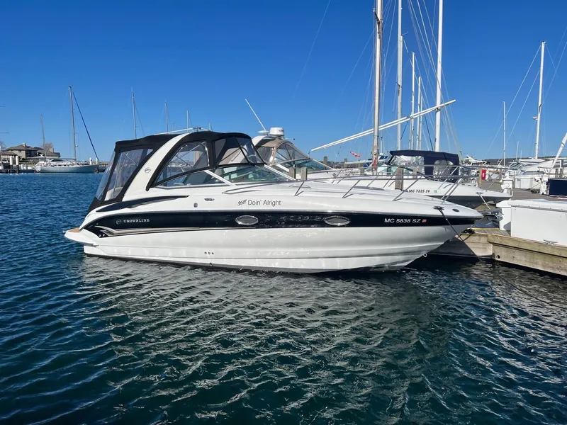 Slide: The Image of 2008 Crownline 270 CR boat docked in a marina under clear blue skies. - 0