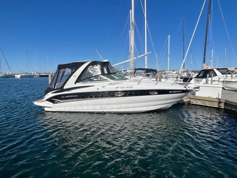 Slide: The Image of 2008 Crownline 270 CR boat docked in a marina under clear blue skies. - 1