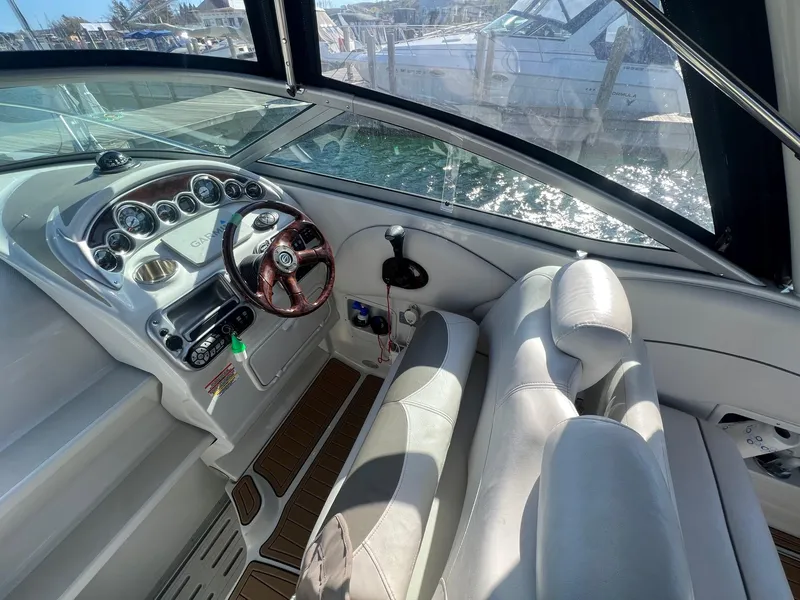 Slide: The Image of 2008 Crownline 270 CR boat cockpit with steering wheel and dashboard controls. - 11