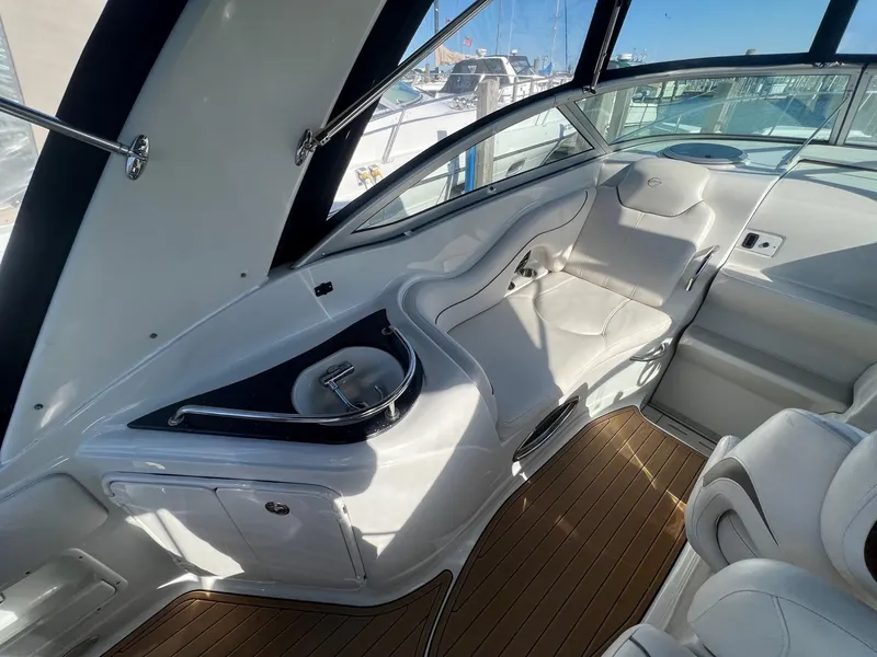 Slide: The Image of 2008 Crownline 270 CR boat interior with white seating and wood flooring. - 14