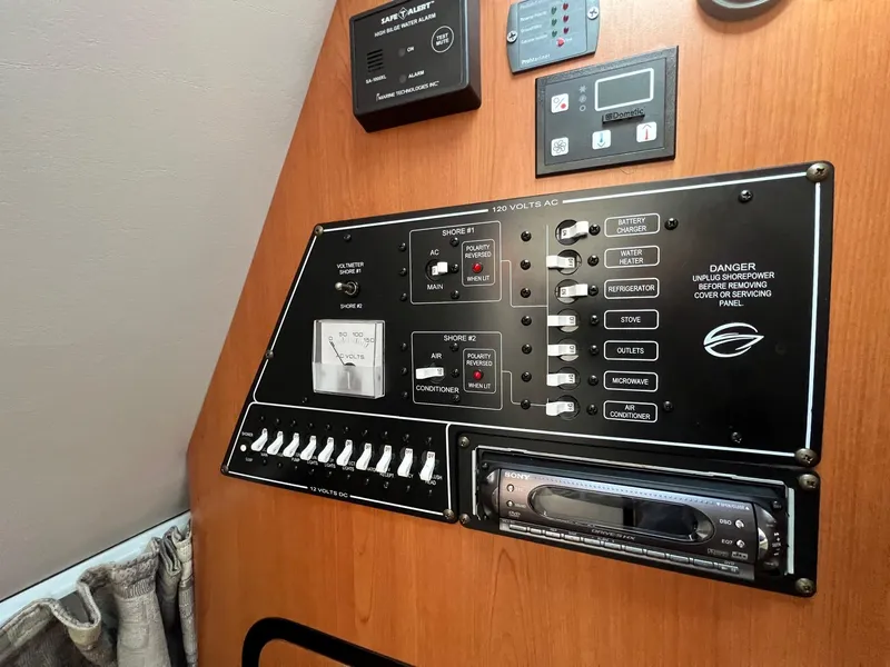 Slide: The Image of Electrical control panel of a 2008 Crownline 270 CR boat, featuring various switches and gauges. - 21