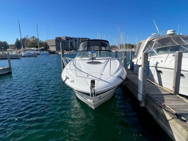 Slide: The Image of 2008 Crownline 270 CR boat docked at marina under clear blue sky. - 3