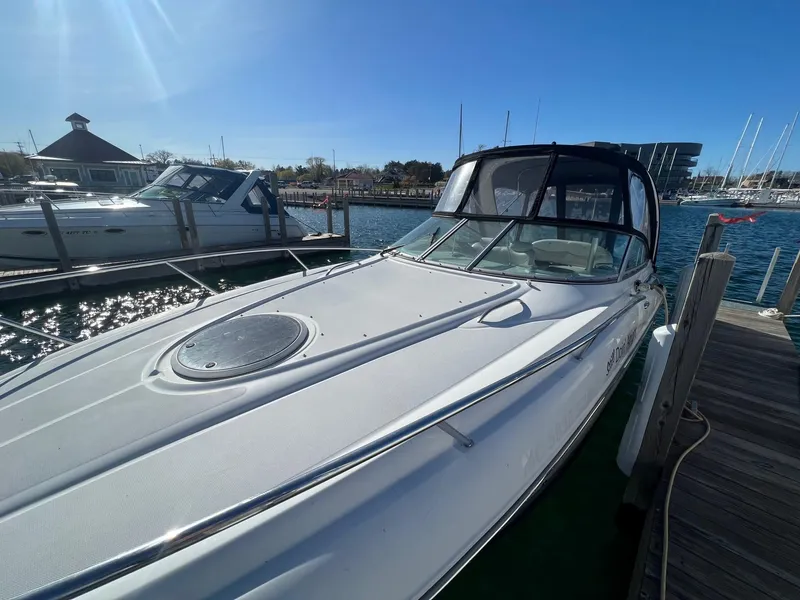 Slide: The Image of 2008 Crownline 270 CR boat docked at marina under clear blue sky. - 4