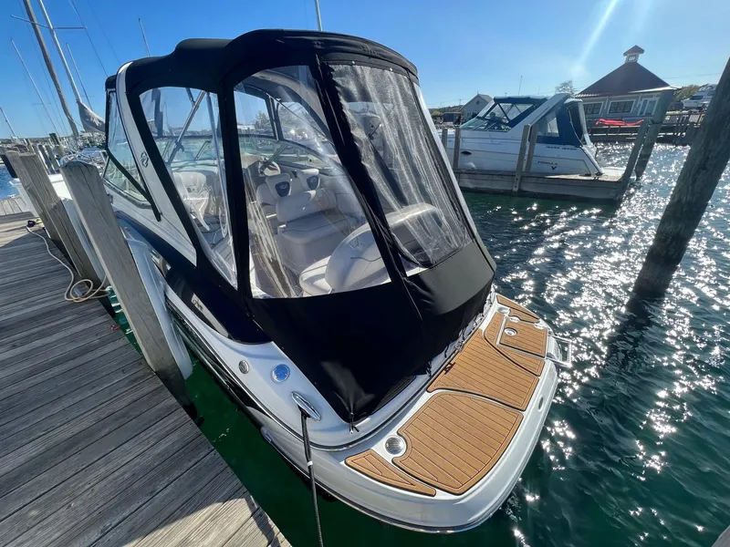 Slide: The Image of 2008 Crownline 270 CR boat docked, featuring a sleek design and covered cockpit. - 6