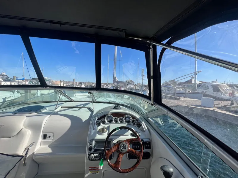Slide: The Image of Interior view of 2008 Crownline 270 CR boat cockpit with marina in background. - 9