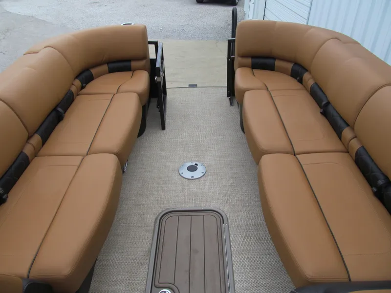 Slide: The Image of 2022 Regency 250 LE3 Sport boat interior with tan seating and carpeted floor. - 11