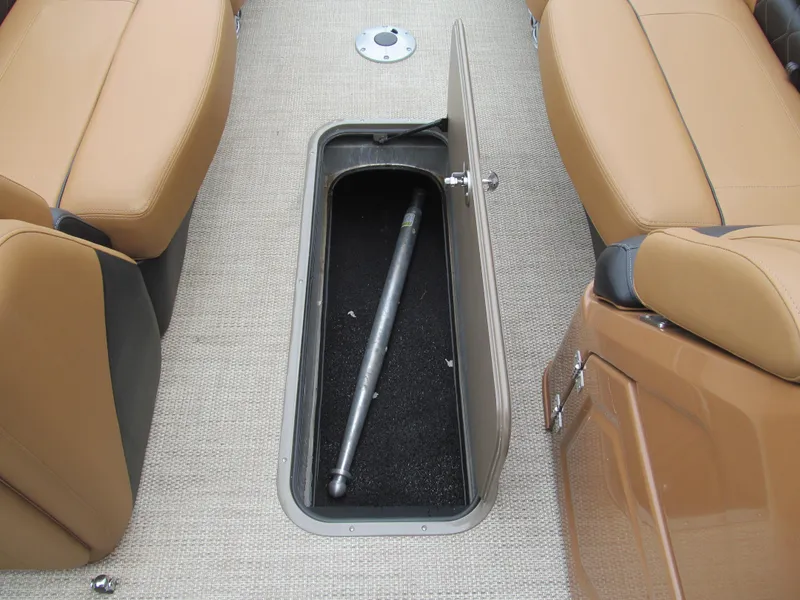 Slide: The Image of 2022 Regency 250 LE3 Sport boat storage compartment with open lid and interior view. - 12