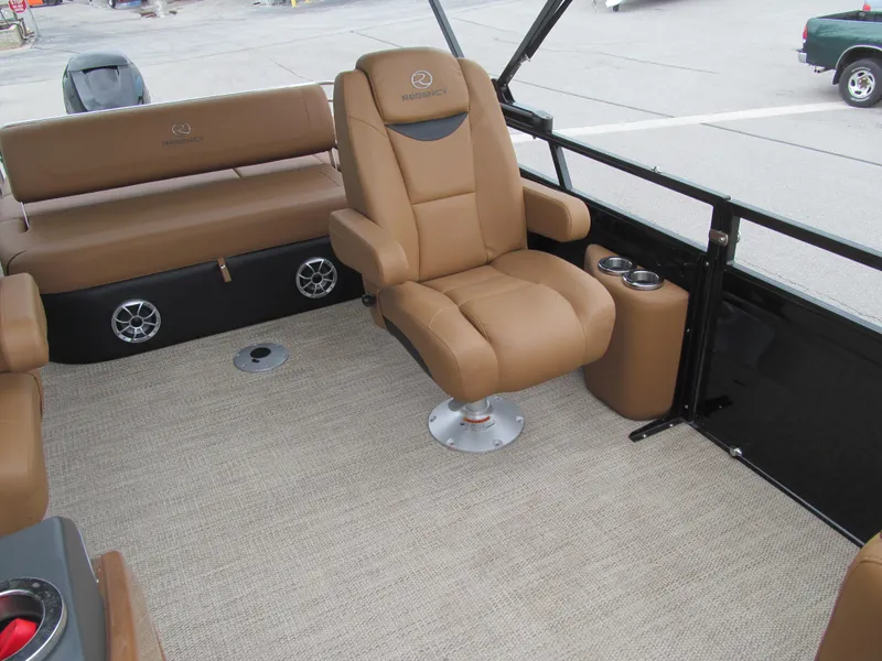 Slide: The Image of Luxurious seating on 2022 Regency 250 LE3 Sport boat with tan upholstery and cup holders. - 15