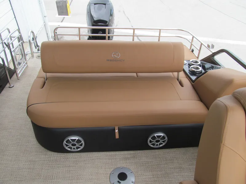 Slide: The Image of 2022 Regency 250 LE3 Sport boat interior with tan seating and built-in speakers. - 17