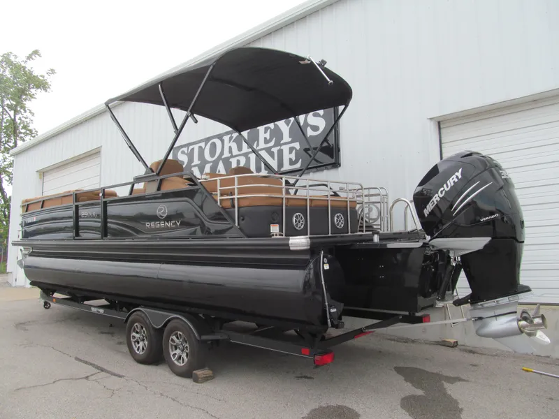 Slide: The Image of 2022 Regency 250 LE3 Sport pontoon boat on trailer, featuring Mercury outboard motor. - 3