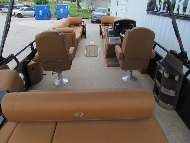 Slide: The Image of 2022 Regency 250 LE3 Sport pontoon boat with tan seating and modern interior design. - 6