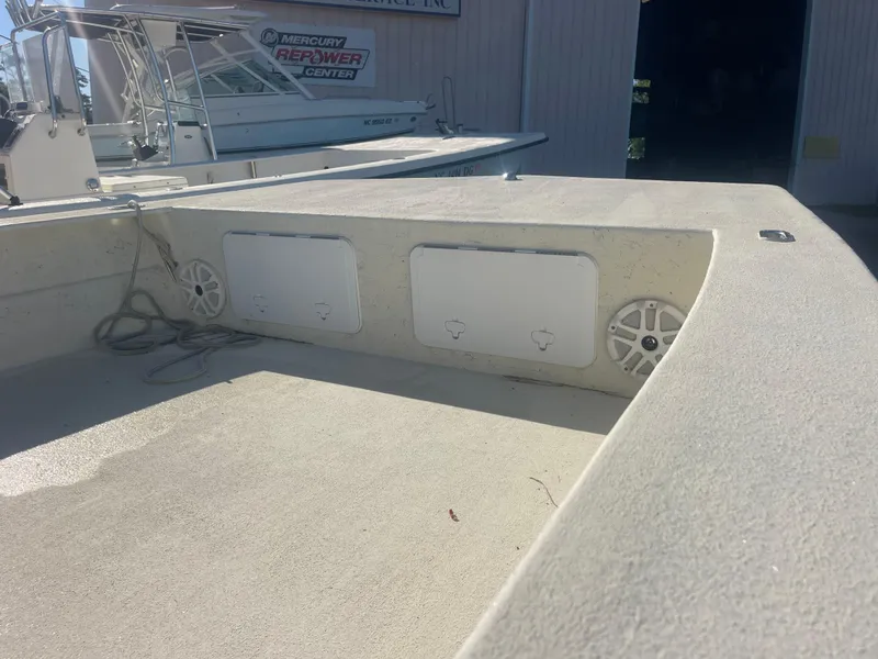 Slide: The Image of 2018 May-Craft 22 Cape Classic boat interior with storage compartments and speakers. - 8