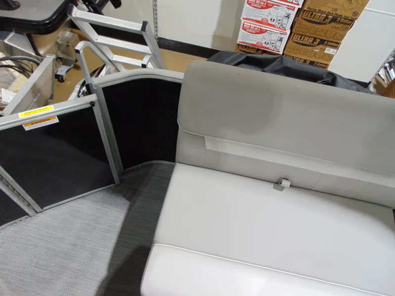 Slide: The Image of 2025 Godfrey EX 1680 CX boat interior with gray seating and storage boxes. - 10