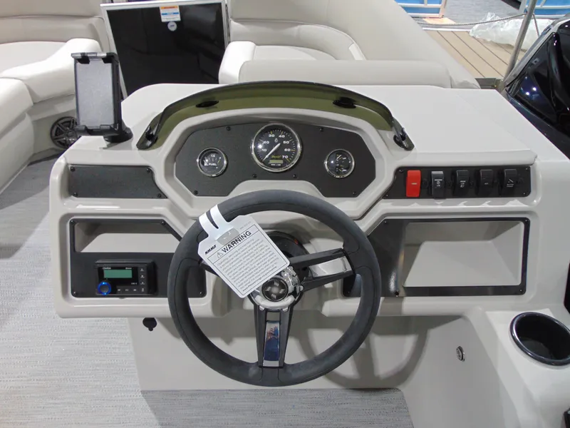 Slide: The Image of 2025 Godfrey EX 1680 CX boat dashboard with steering wheel and control panel. - 12
