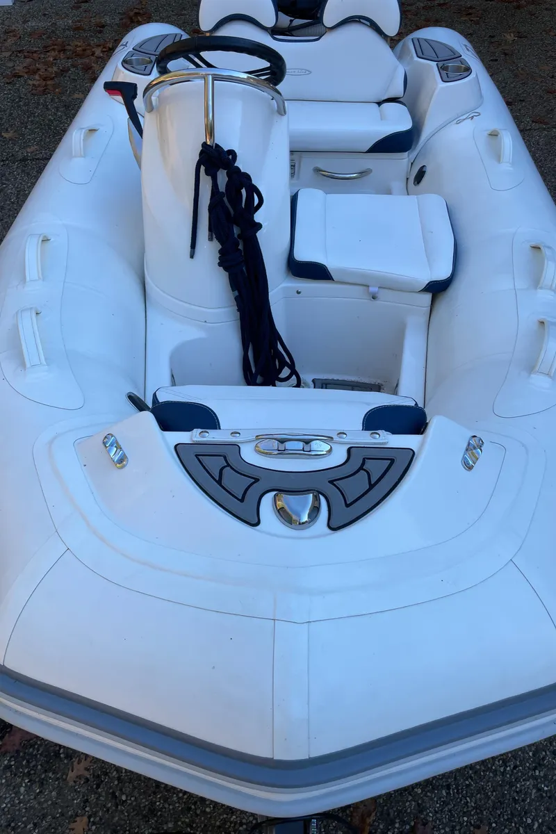 Slide: The Image of 2022 Zodiac Yachtline 360 inflatable boat with steering console and seating, viewed from above. - 12