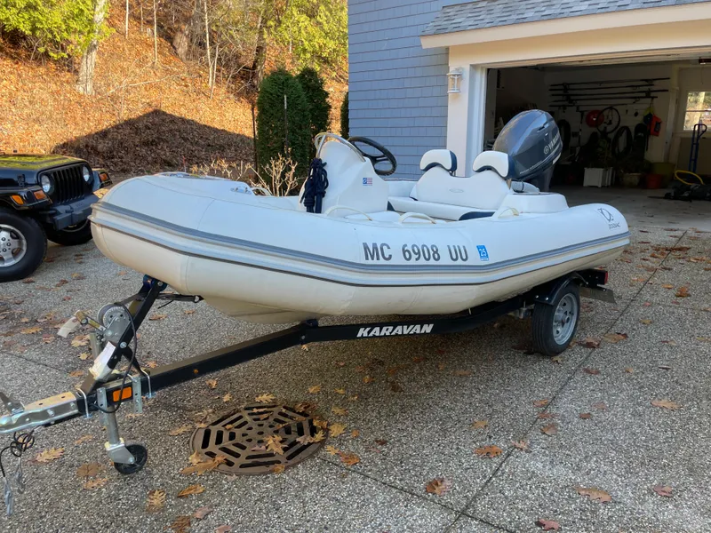 Slide: The Image of 2022 Zodiac Yachtline 360 inflatable boat on Karavan trailer, parked in driveway. - 4