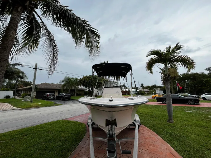 Slide: The Image of 2013 Grady-White Fisherman 180 boat on trailer, parked in a tropical residential area. - 10