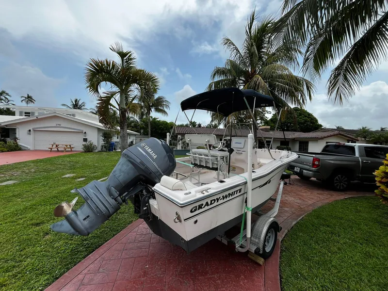 Slide: The Image of 2013 Grady-White Fisherman 180 boat on trailer, parked in a tropical residential driveway. - 13