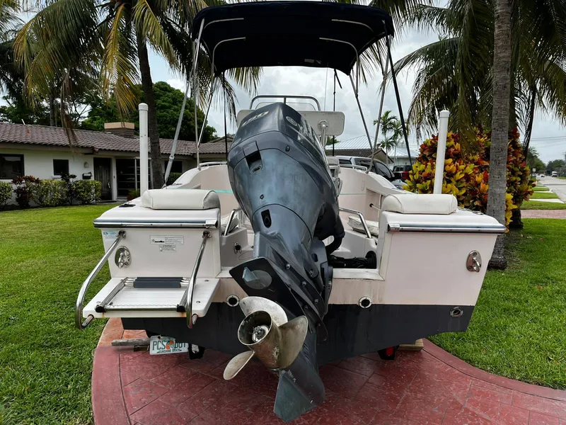Slide: The Image of 2013 Grady-White Fisherman 180 boat with outboard motor, parked on a driveway. - 14