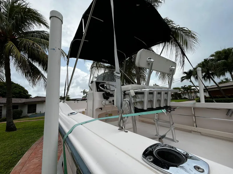 Slide: The Image of 2013 Grady-White Fisherman 180 boat with canopy, docked near palm trees. - 17