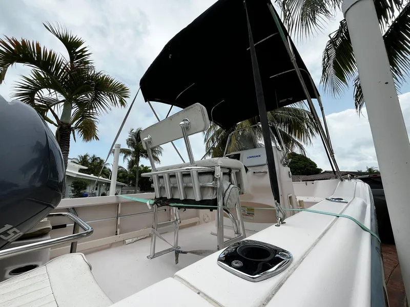 Slide: The Image of 2013 Grady-White Fisherman 180 boat with canopy, surrounded by palm trees. - 18