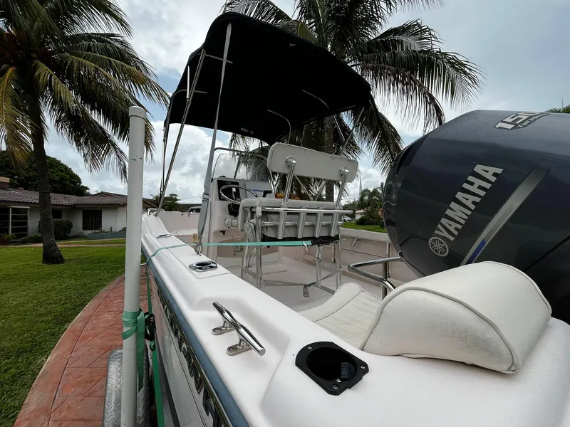 Slide: The Image of 2013 Grady-White Fisherman 180 boat with Yamaha engine, parked near palm trees. - 19